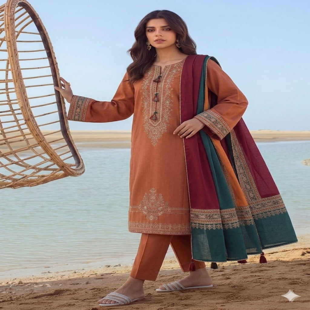Woman in traditional outfit by a beach with a woven chair.