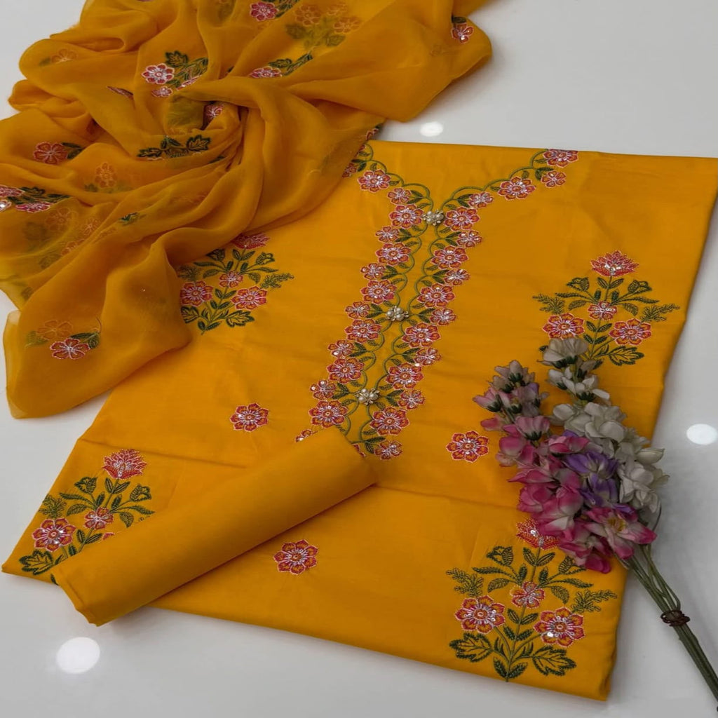 Yellow fabric with floral embroidery on a white background