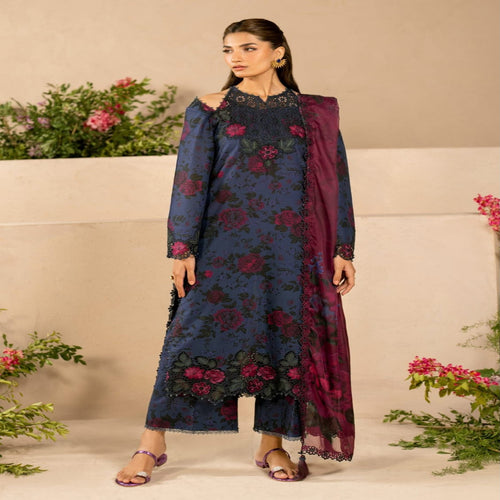 Woman wearing a dark blue floral dress with a matching dupatta against a neutral background