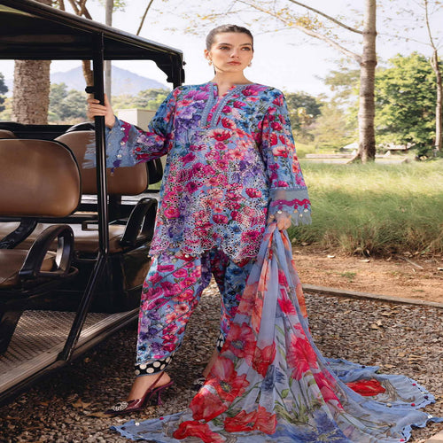 Woman in a colorful floral outfit standing next to an open-top vehicle in a natural setting.