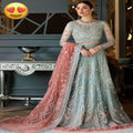 Woman in a light blue and pink embroidered traditional outfit with a heart emoji above.