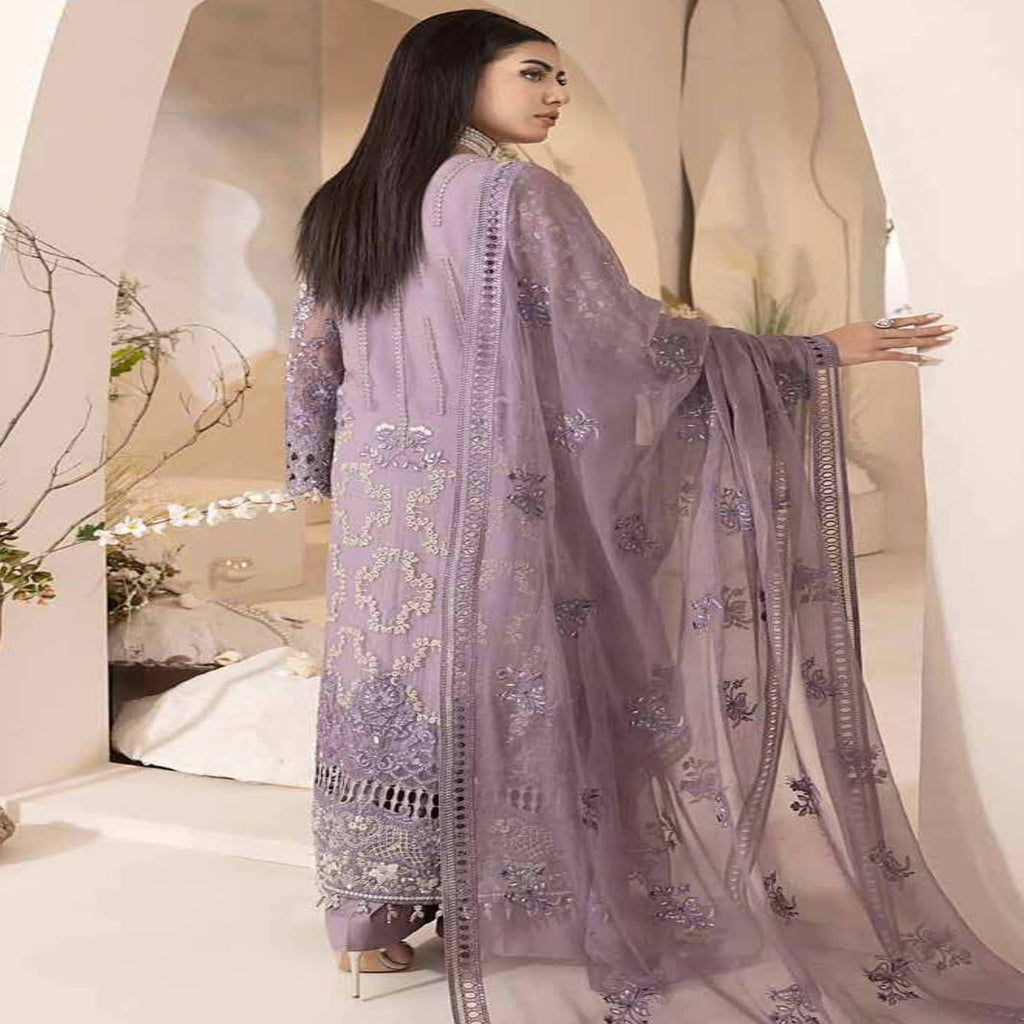 Woman wearing a lavender embroidered dupatta in an indoor setting