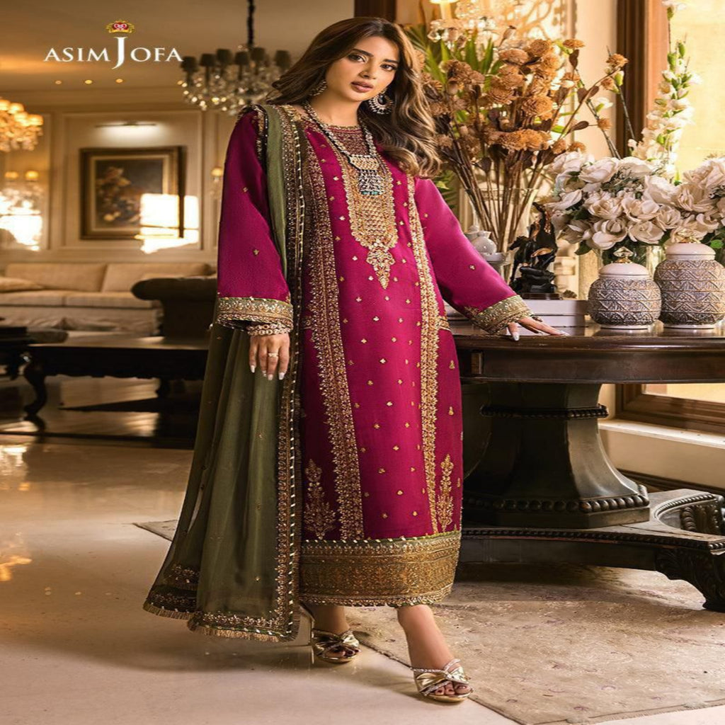 Woman in a traditional outfit with intricate designs in a decorated room.